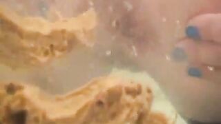 Woman shitting in the bathtub water