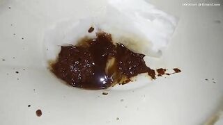 Woman fucks her asshole while sitting on a pile of shit