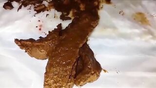 Skinny blonde girl smearing shit on her pussy