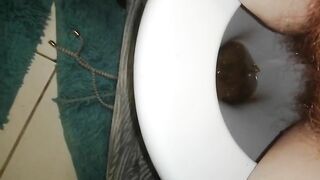 Woman poops in toilet with blue matt