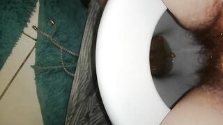 Woman poops in toilet with blue matt