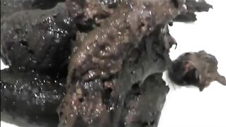 Brunette shits a black turd