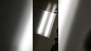 A woman with a bondage web pattern on her ass pulls apart her ass cheeks