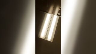 Man sticks his tongue out while wearing a fishnet bodysuit