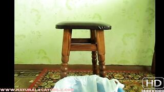 Pooping into a plastic bag from a chair