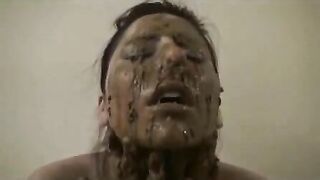 Pretty girl rubs warm shit on her face