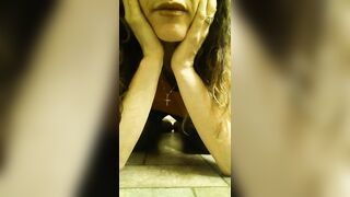 Girl in black leather shorts takes a huge shit in a glass bowl