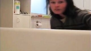 Young brunette milf teasing and pooping in the bathroom