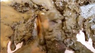 Smearing her feet in the shit