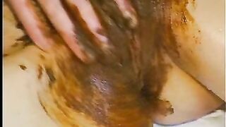 Covering her pussy with shit
