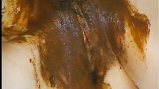 Covering her pussy with shit