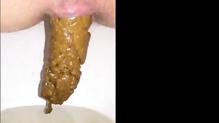 Girl shitting long hard yellow turd