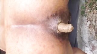 Hairy woman shitting doggy closeup