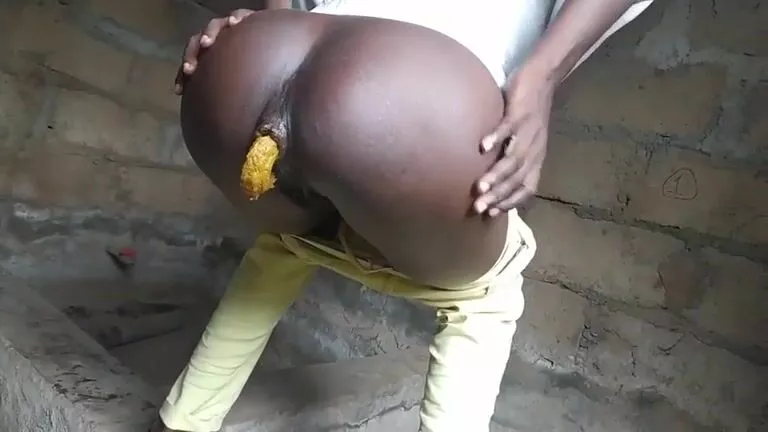 Ebony lady poops in a building site