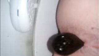 Woman takes a massive shit on the toilet