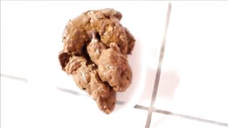 Sexy babe shitting in a plastic bowl