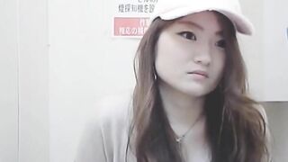 Girl in hat crouches down and takes a shit in public