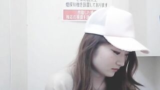 Girl in hat crouches down and takes a shit in public