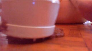 Mature woman masturbating with vibrator while shitting