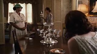 Woman pisses in a sink while wearing a hat