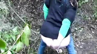 Dirty mature lady pooping in the garden