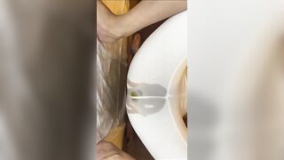 Woman in lingerie takes a massive shit in a plastic bag