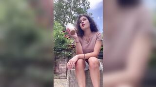 Woman sits on toilet and takes a shit in a cup