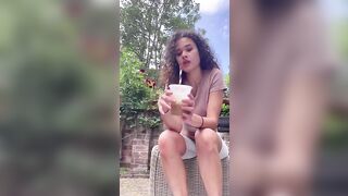 Woman sits on toilet and takes a shit in a cup