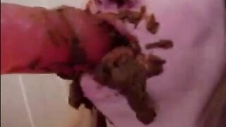 Dirty girl sucking and licking a shitty covered dildo