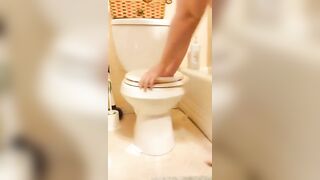 Woman takes a shit on the toilet and shows it to the camera