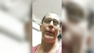 Mature brunette lady in glasses showing her poop