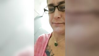 Mature brunette lady in glasses showing her poop