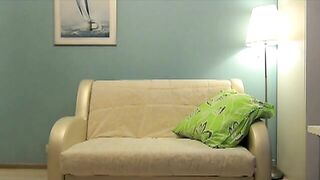Beautiful Anja shits near the sofa
