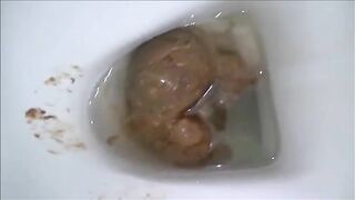 Blonde milf shitting in the toilet while standing