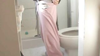 Woman sitting on toilet while reading a book and taking a shit