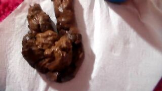 Nice poo over pink bathmat closeup