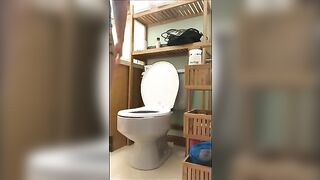 Woman takes a big shit on the toilet