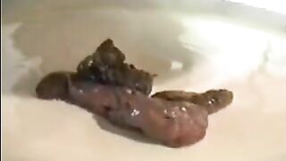 Girl shits in a bowl on the floor and spreads it with her hands
