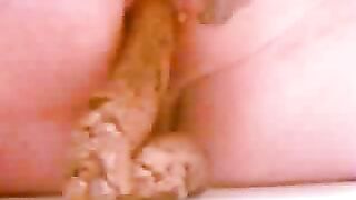 Man eats huge pile of shit off a table