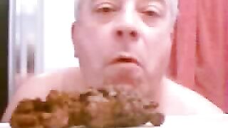Man eats huge pile of shit off a table