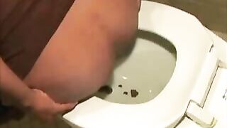 Slutty ebony lady dropping shit in the toilet