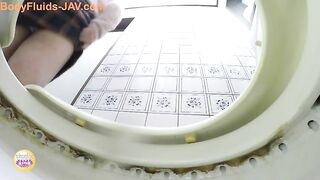 Girl sitting on the toilet, shits into a white bowl.