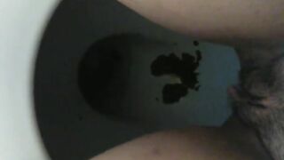 Messy dark shit in the toilet