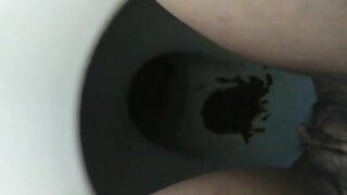 Messy dark shit in the toilet