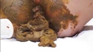 Mature lady masturbating with brush while shitting