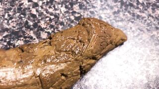 Woman drops a long shit onto the floor