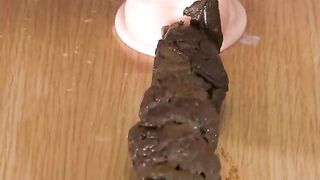 Woman squats on a box and takes a huge shit