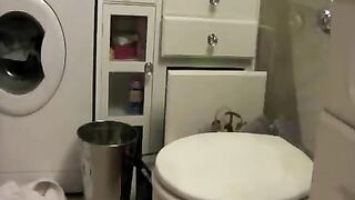 Girl flicks a big turd off the toilet seat