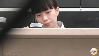 Girl takes a big shit on the floor next to a table