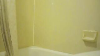 A woman squats and spreads her asshole in the bathtub
